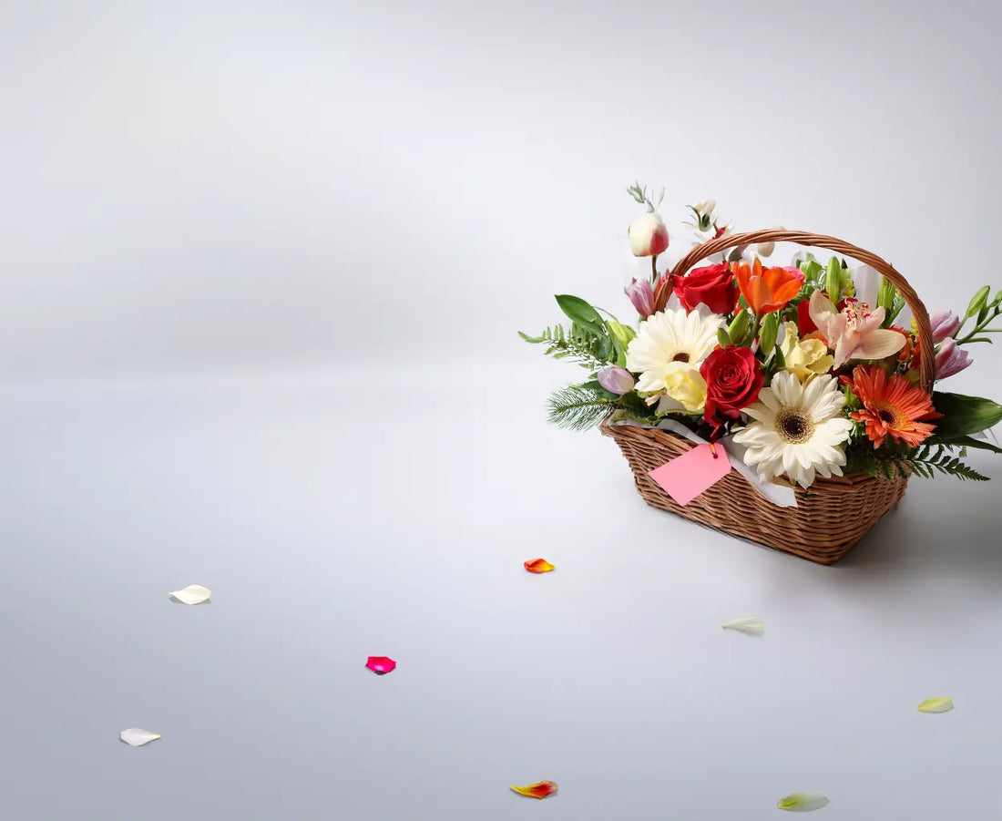Basket of flowers with a pink tag on a light gray background
