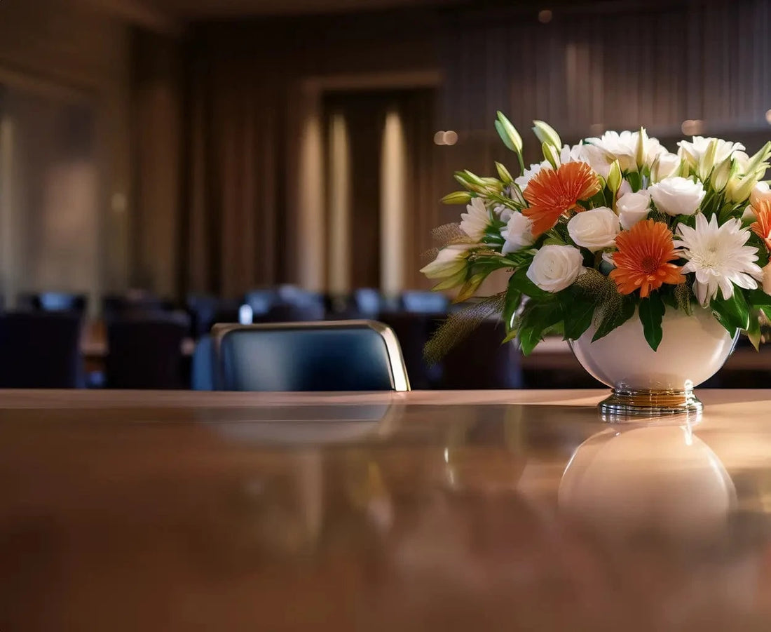 Floral arrangement in a vase on a table in a conference room setting
