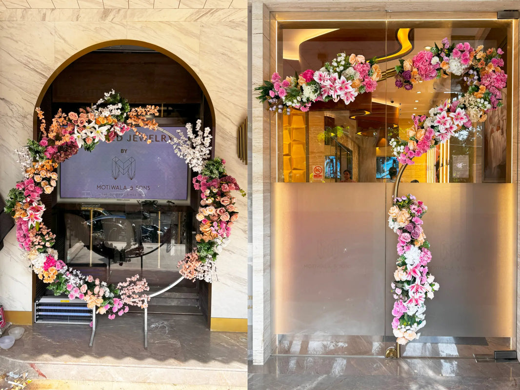 Decorative floral arches in front of a store entrance with a visible brand logo.