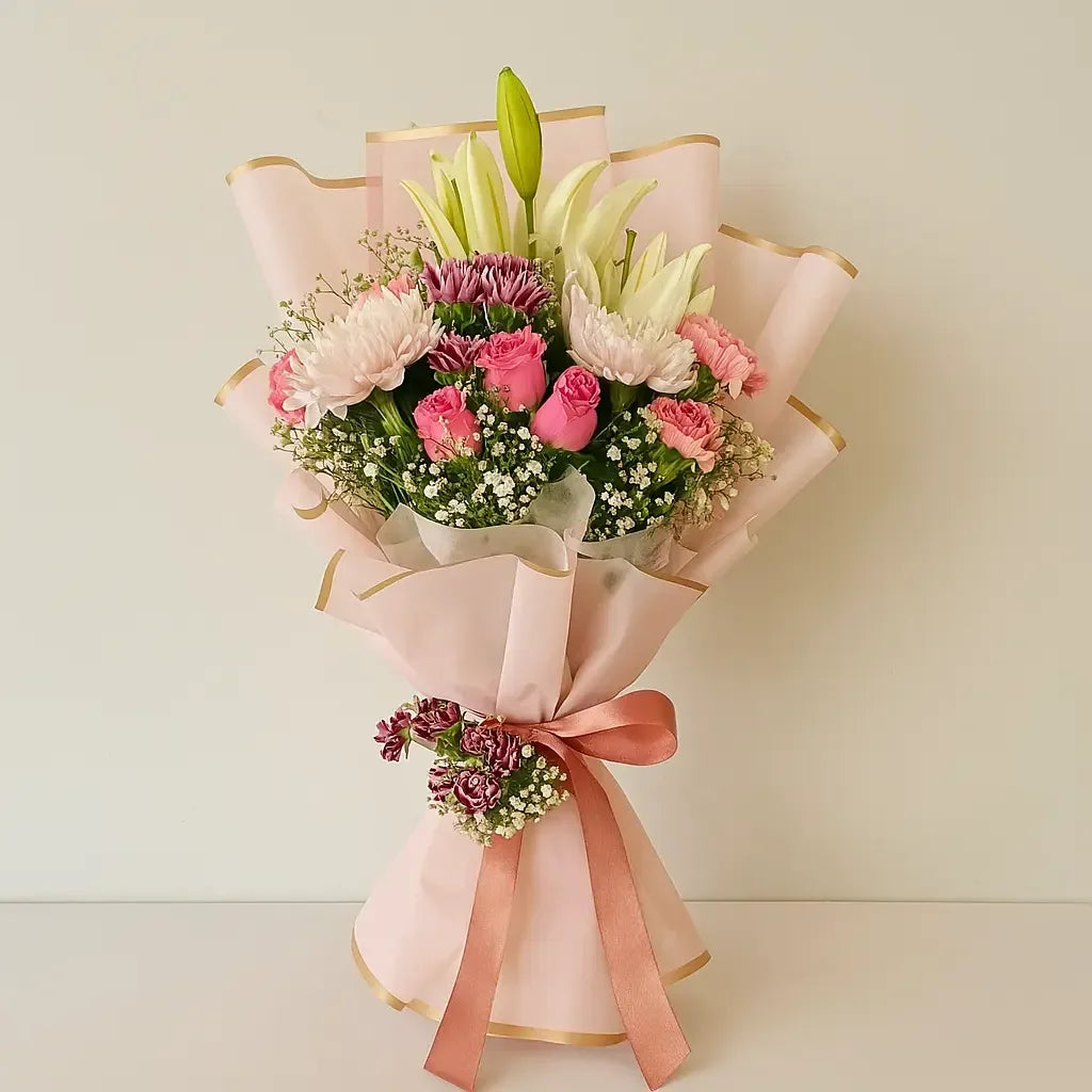 Lilies, Carnation & Disbud in Blush Wrap - atfleurs