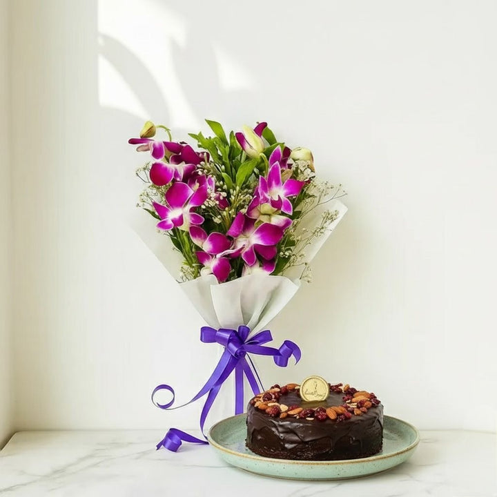 Bouquet of purple orchids with a chocolate cake on a white surface Bento Cake and Flower Bouquet