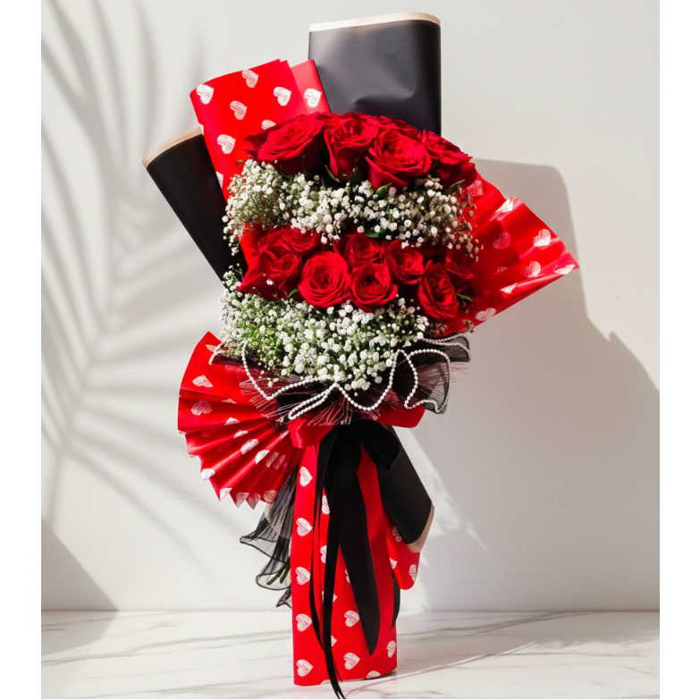 Bouquet of red roses with decorative ribbons on a white background