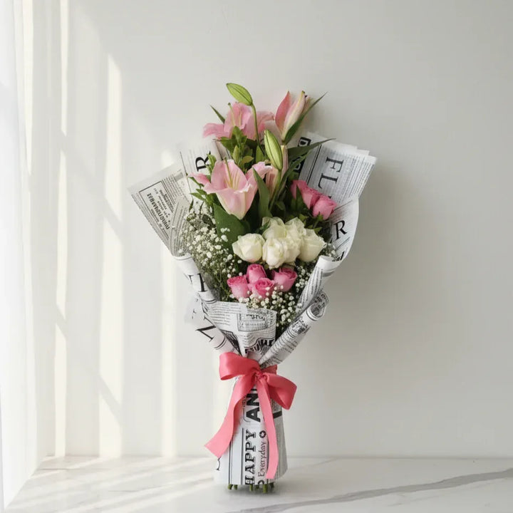 Pink Lilies and Roses in Newspaper Wrap - atfleurs