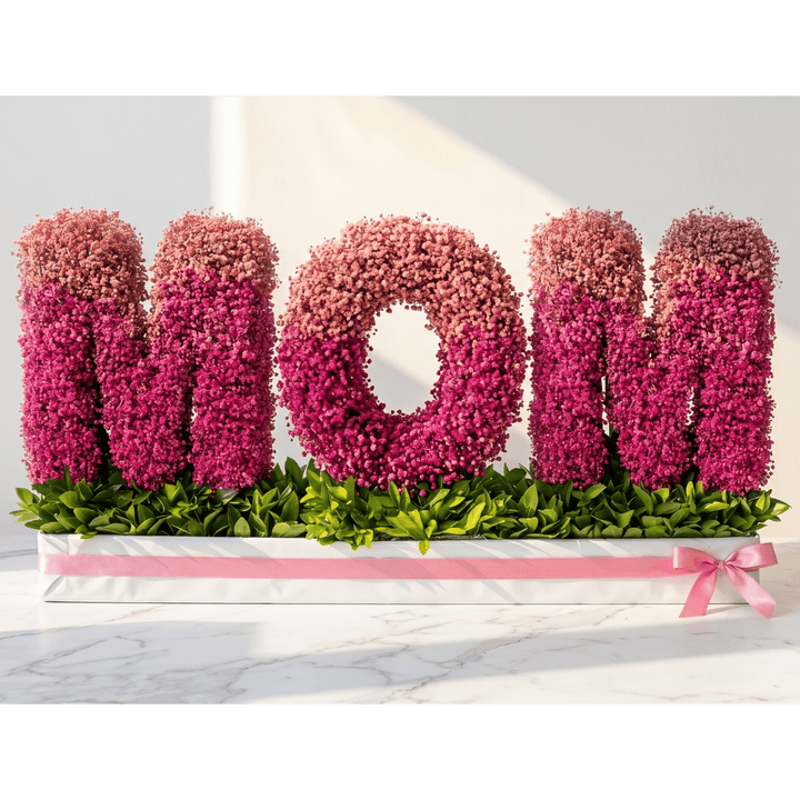Floral arrangement spelling 'MOM' on a white background