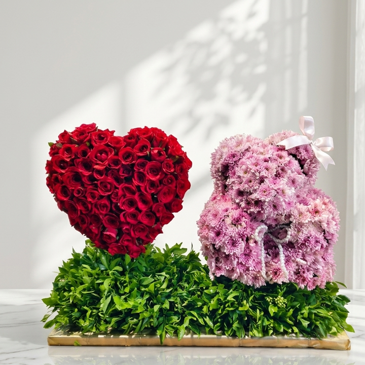 Romantic floral arrangement with red rose heart and pink chrysanthemum teddy bear with pearl necklace on green foliage base by At Fleurs Bandra Mumbai