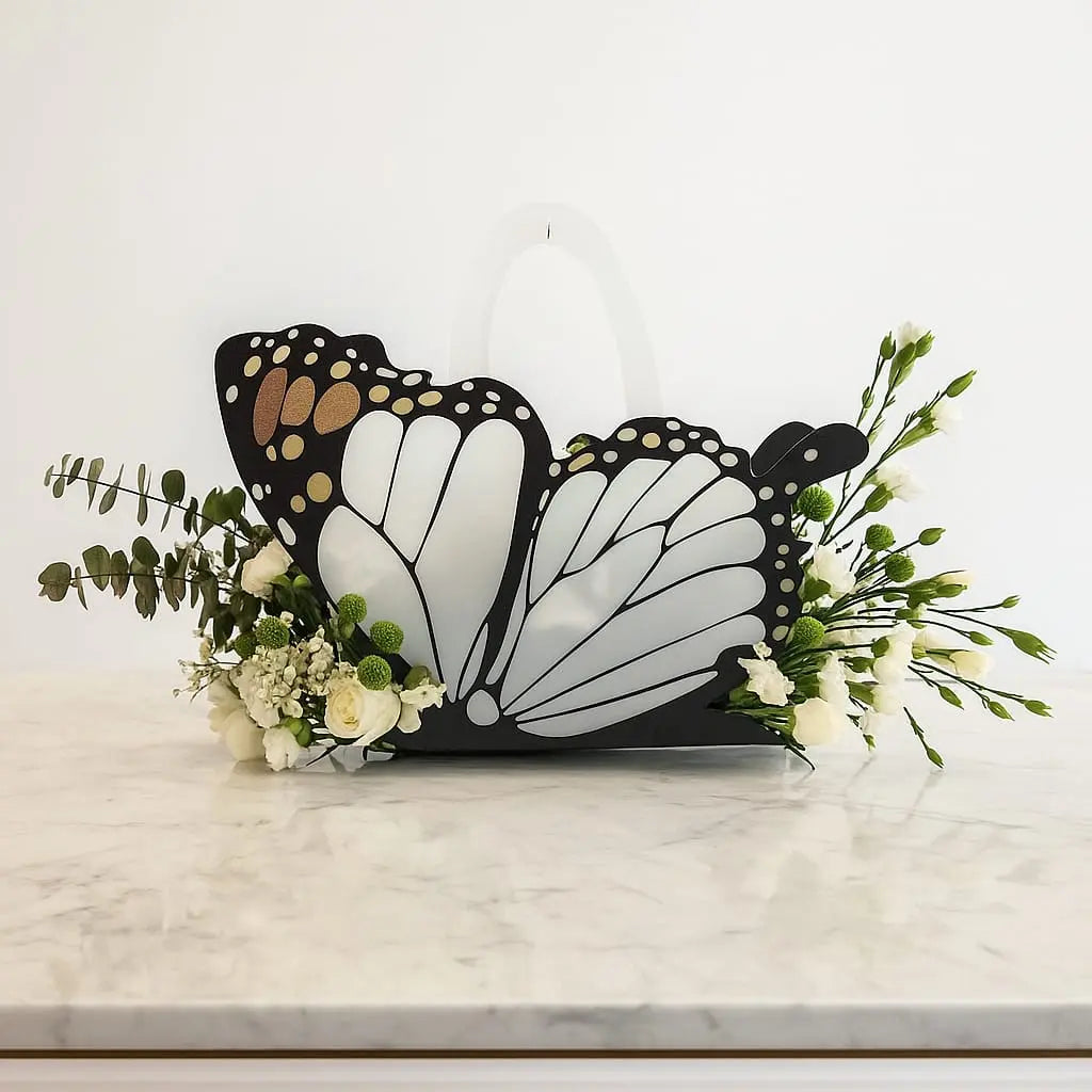 Butterfly-shaped decorative item with flowers on a marble surface