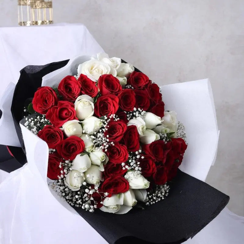 Bouquet of red and white roses on a neutral background