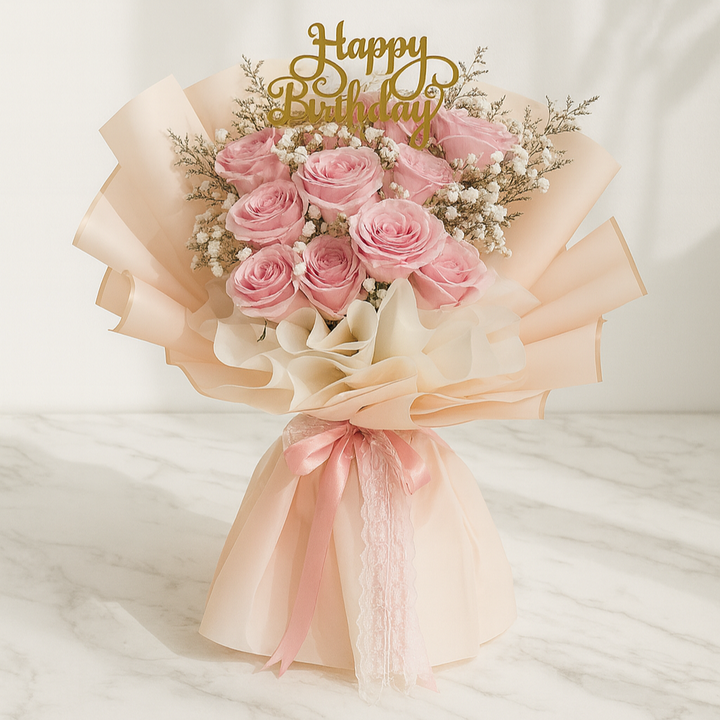 Bouquet of pink roses with a 'Happy Birthday' topper on a white background. Birthday bouquet