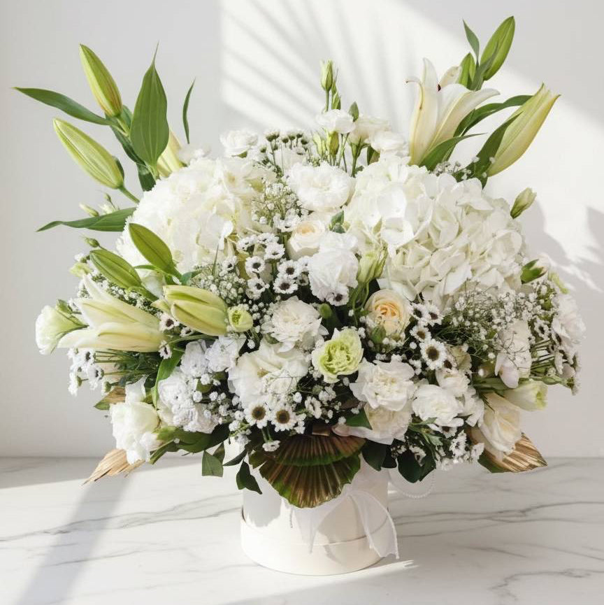 Bouquet of white and green flowers in a vase on a marble surface