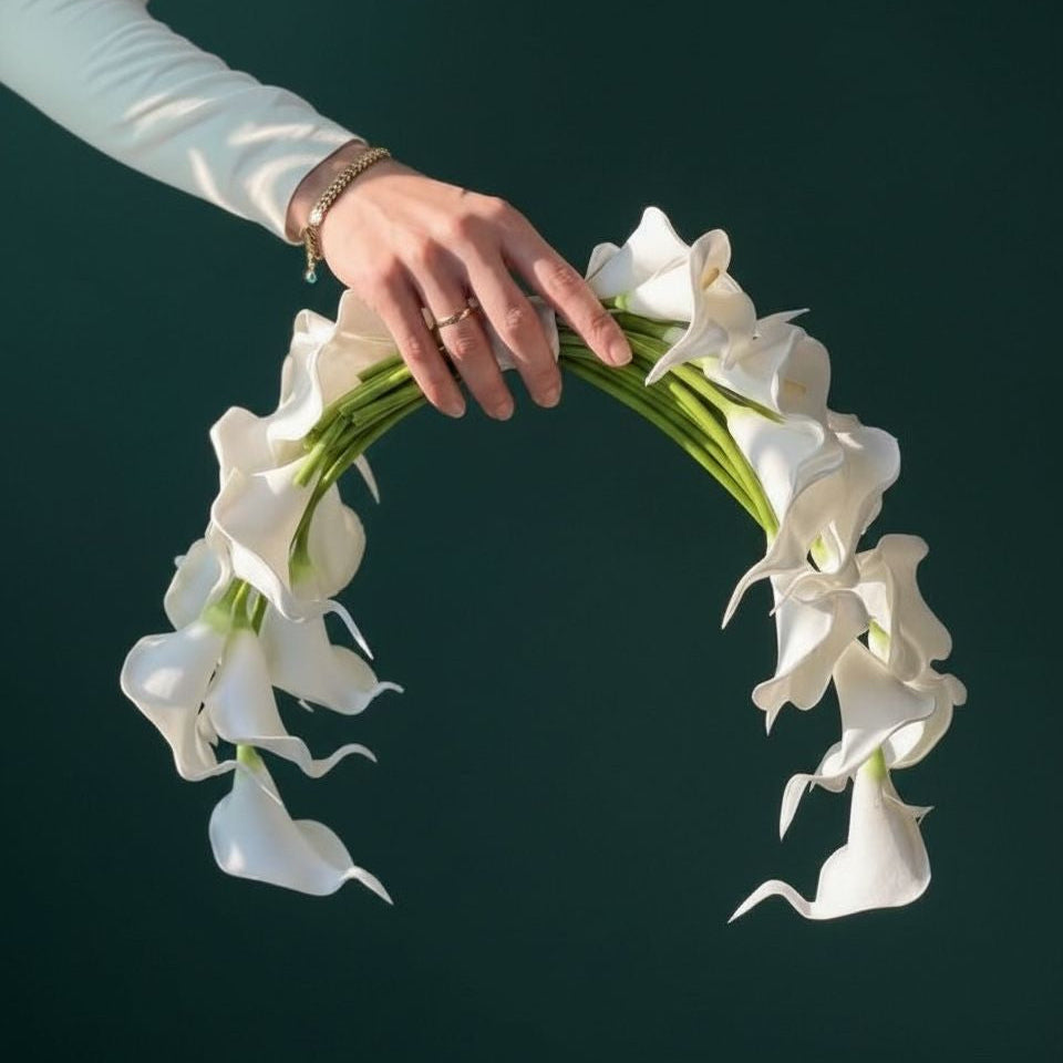 Hand holding a circle arrangement of white flowers bridal