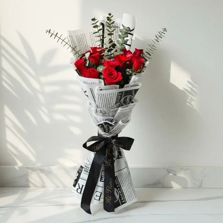 Red Roses in Newspaper Wrap - atfleurs