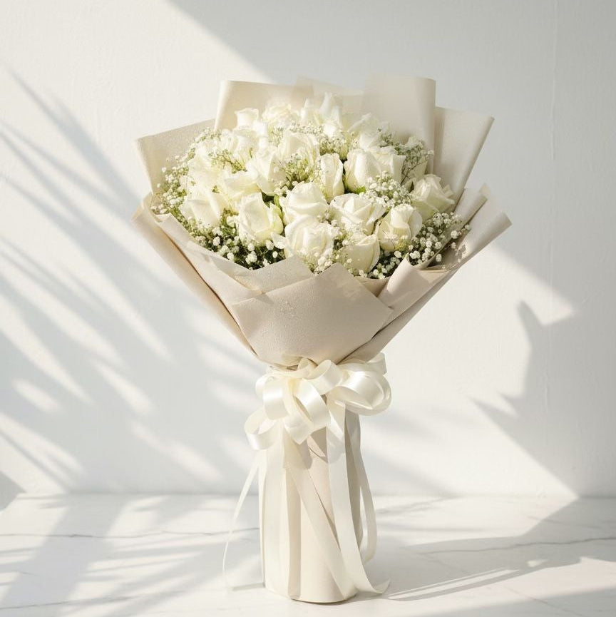 Bouquet of white flowers wrapped in beige paper with a white ribbon on a light background fresh flowers bouquet