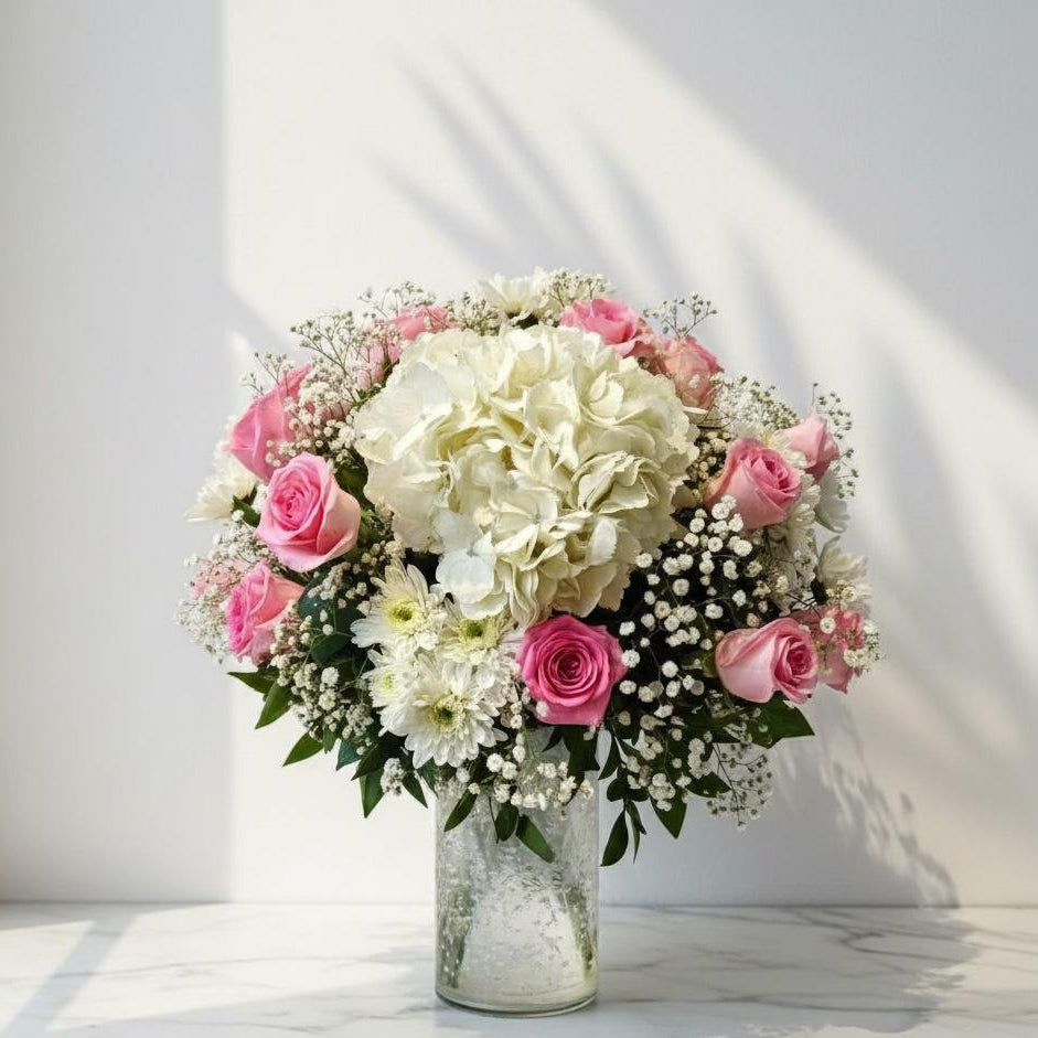 Bouquet of pink and white flowers in a clear vase on a light background fresh flowers 
