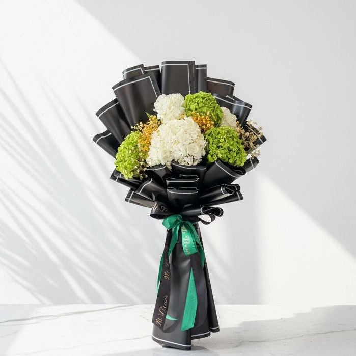 Bouquet of flowers wrapped in black ribbons with a green bow on a white background hand bouquet