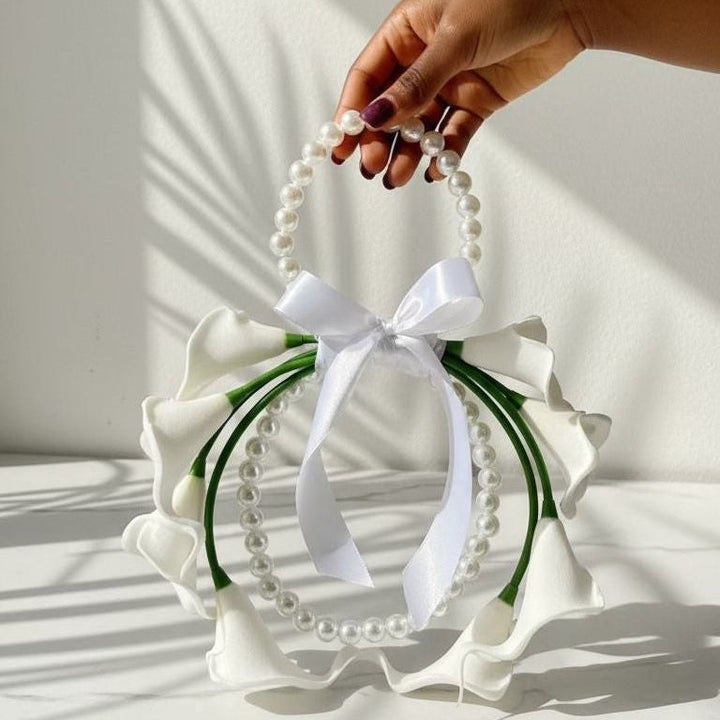 Hand holding a decorative ring with white flowers and a bow on a white background wedding flowers bridal bouquets