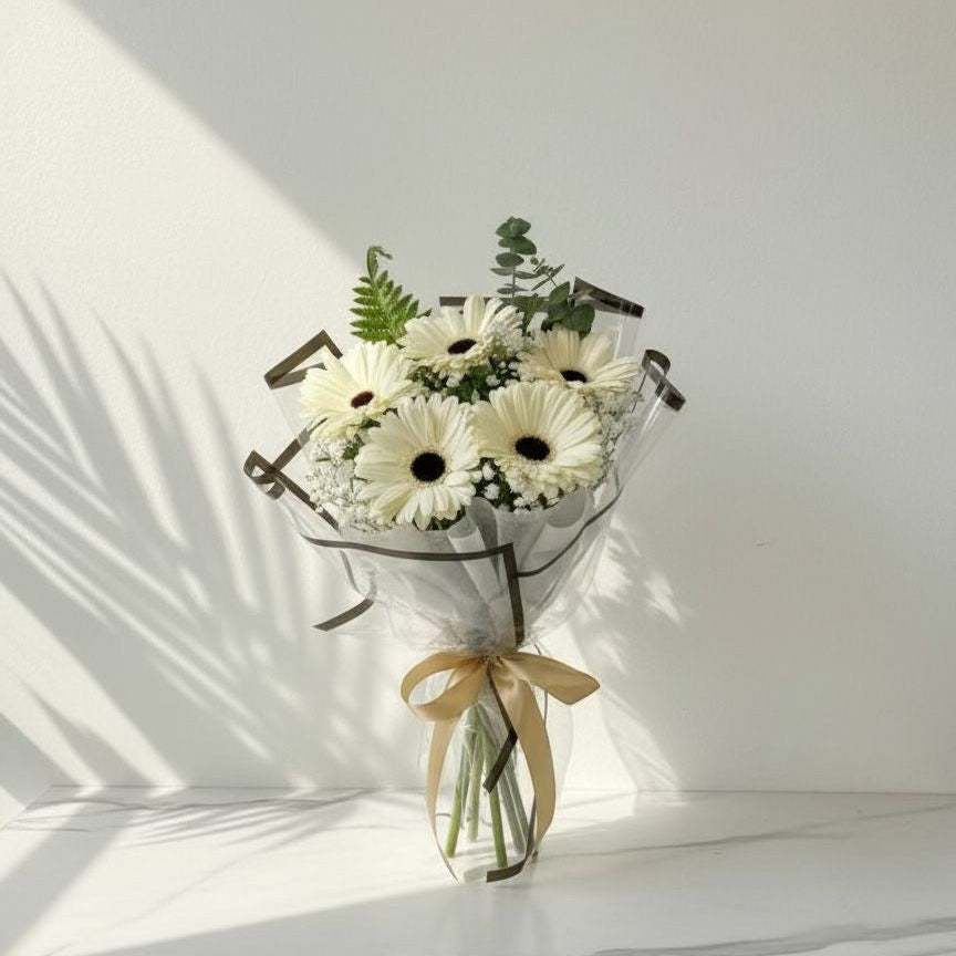 Bouquet of white flowers with greenery in a decorative metal stand on a light background
fresh flower bouquets
