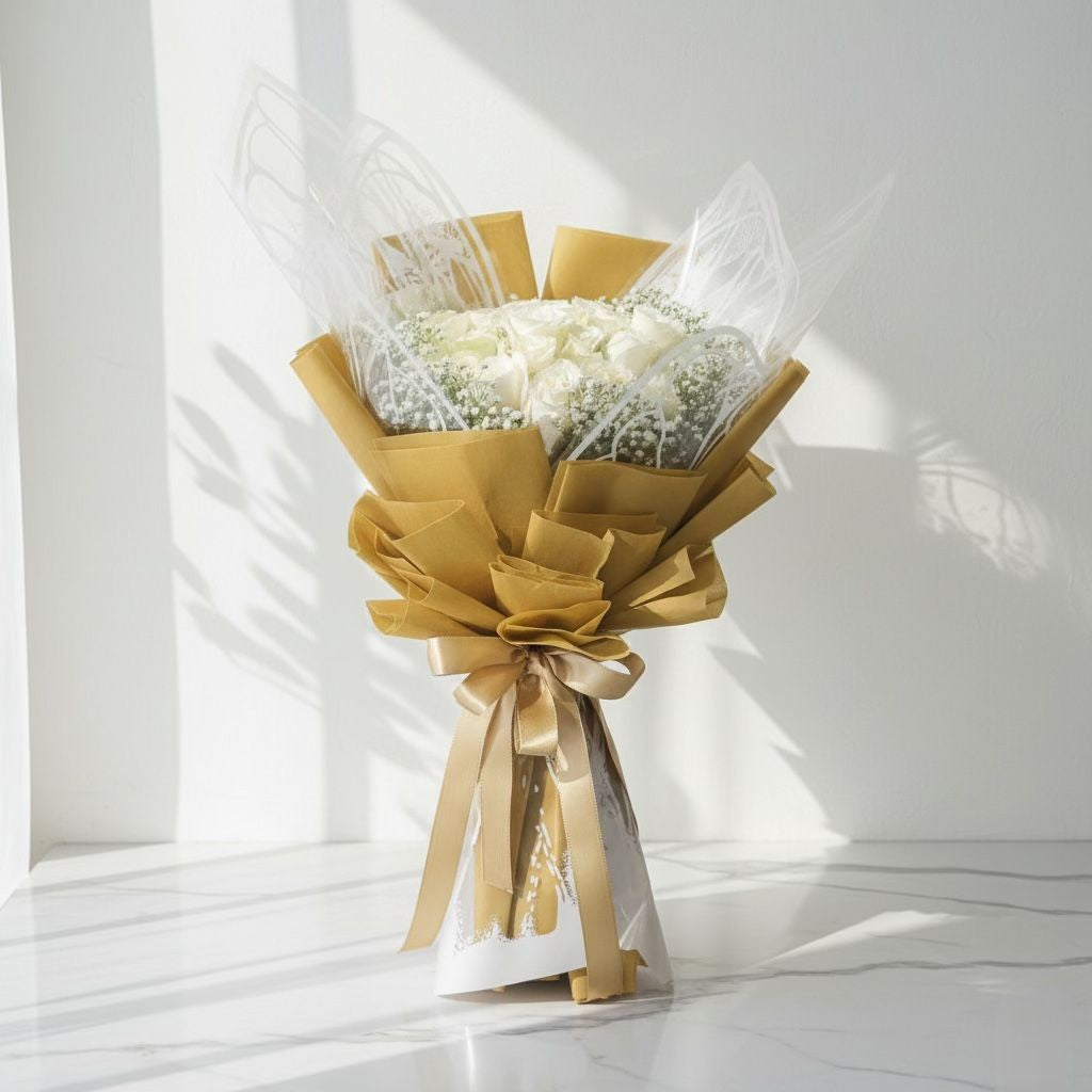 Bouquet of white flowers wrapped in brown paper with a gold ribbon fresh flowers same day delivery